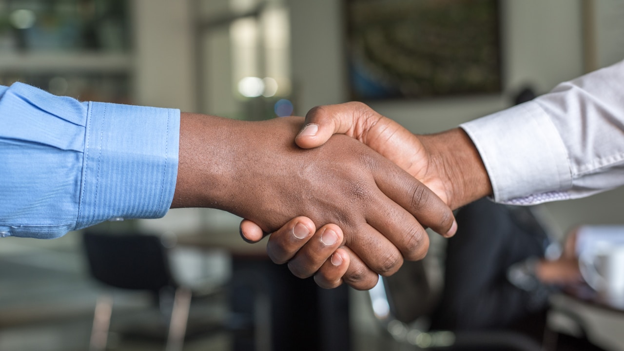 Business handshake representing international trade agreements in vape industry