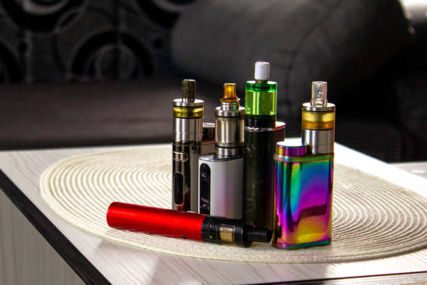 Wholesale buyer inspecting disposable vape devices with mesh coil technology specifications on packaging